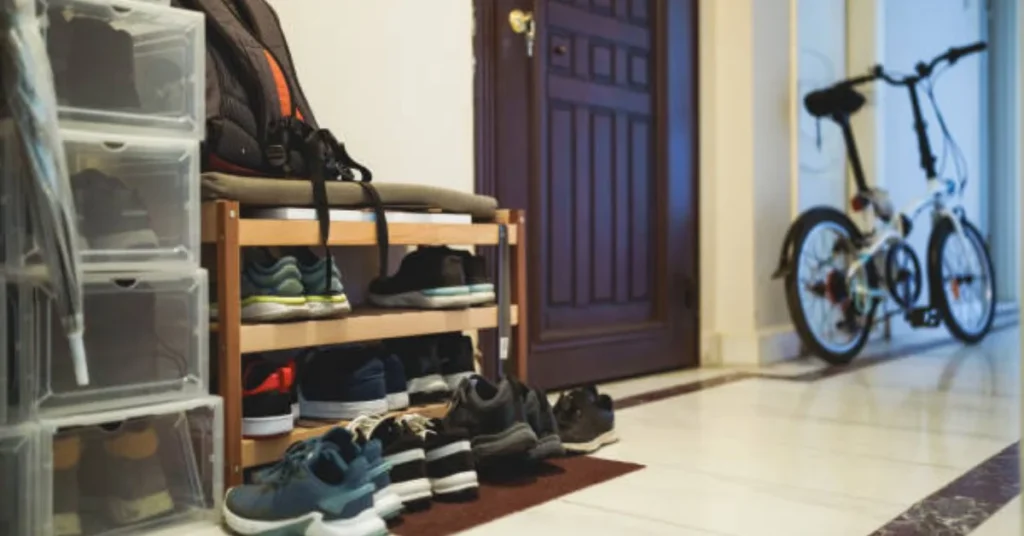 running shoes and gym bag organized by front door with bike ready for morning workout routine