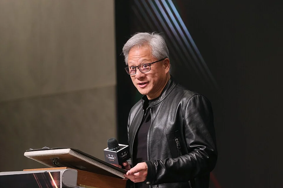 Jensen Huang Nvidia CEO wearing signature black leather jacket at podium