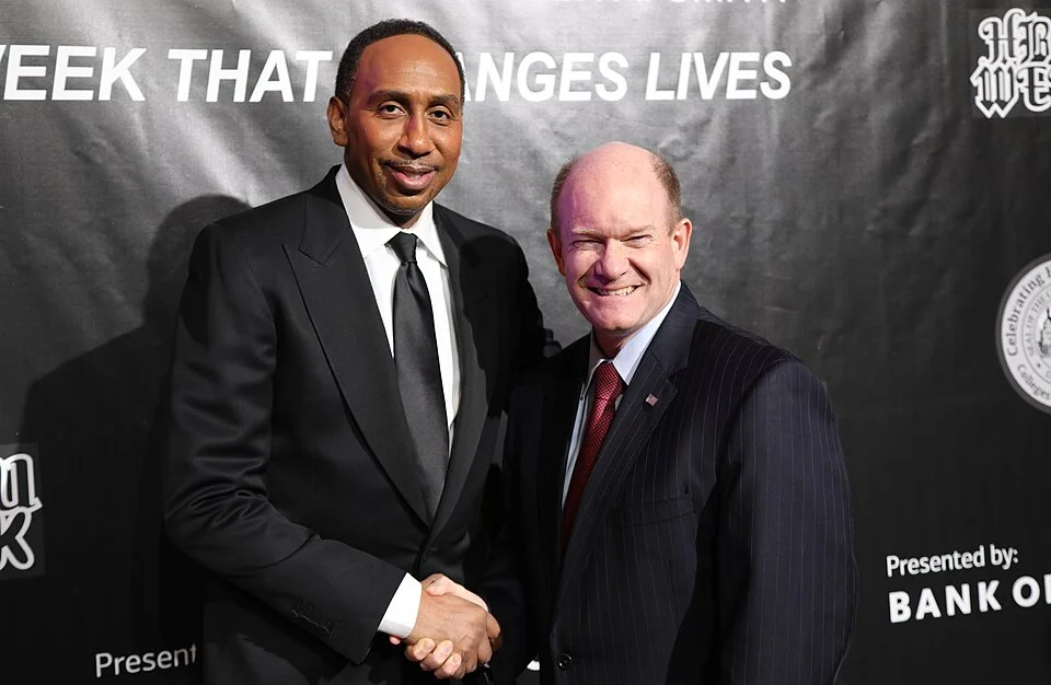 Stephen A. Smith shaking hands at professional event