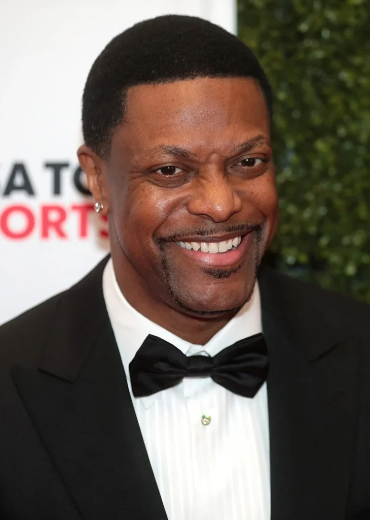 Chris Tucker smiling in tuxedo at formal event