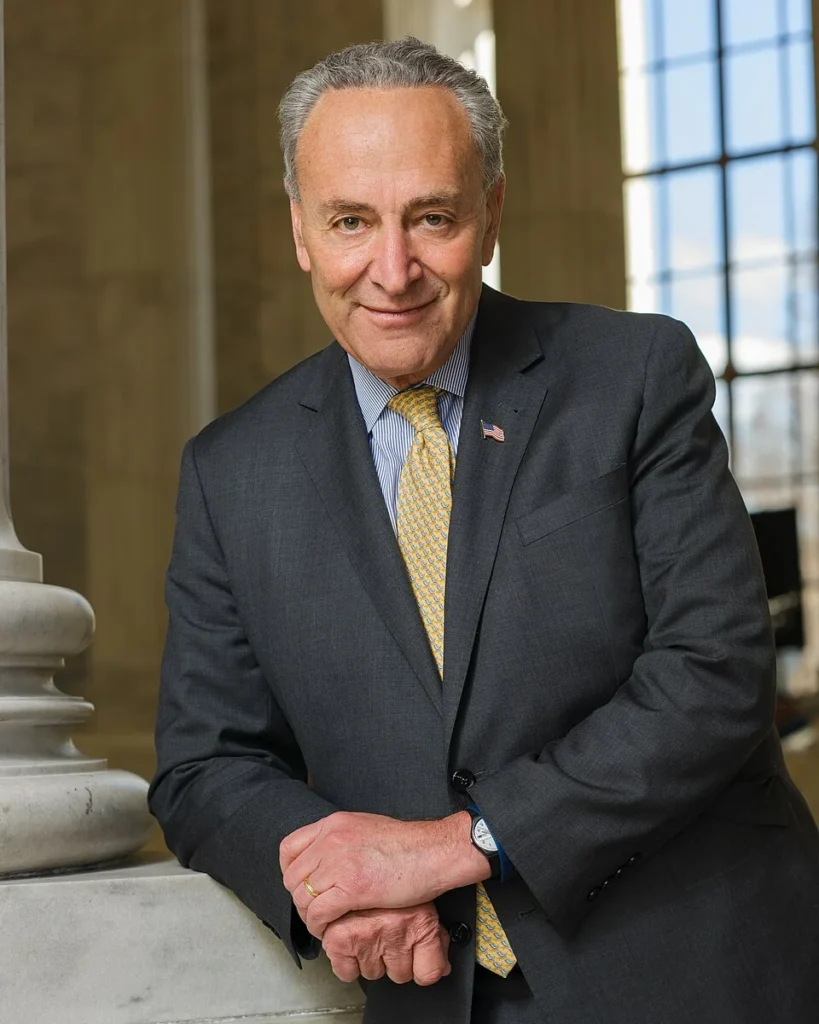 Chuck Schumer official portrait in dark suit with yellow tie