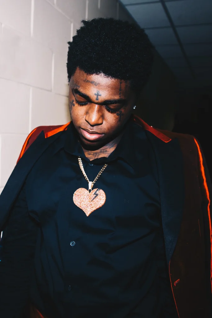 Kodak Black posing in colorful outfit during photoshoot
