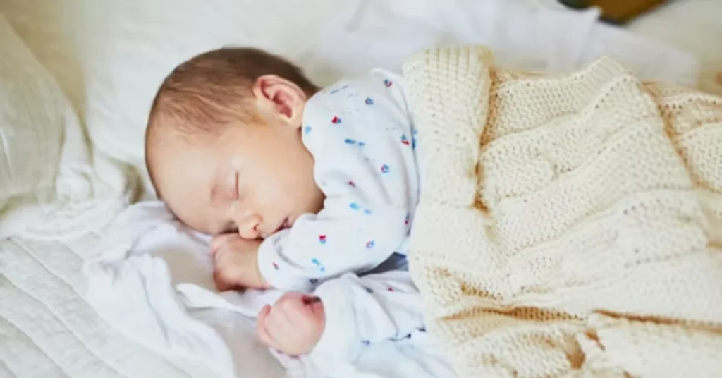 Baby sleeping peacefully after 9 month sleep regression ends showing calm resolved sleep pattern