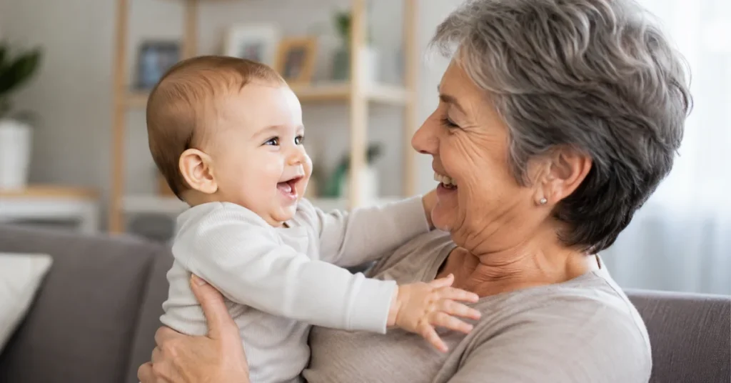 Smiling baby reaching out while being held by grandmother