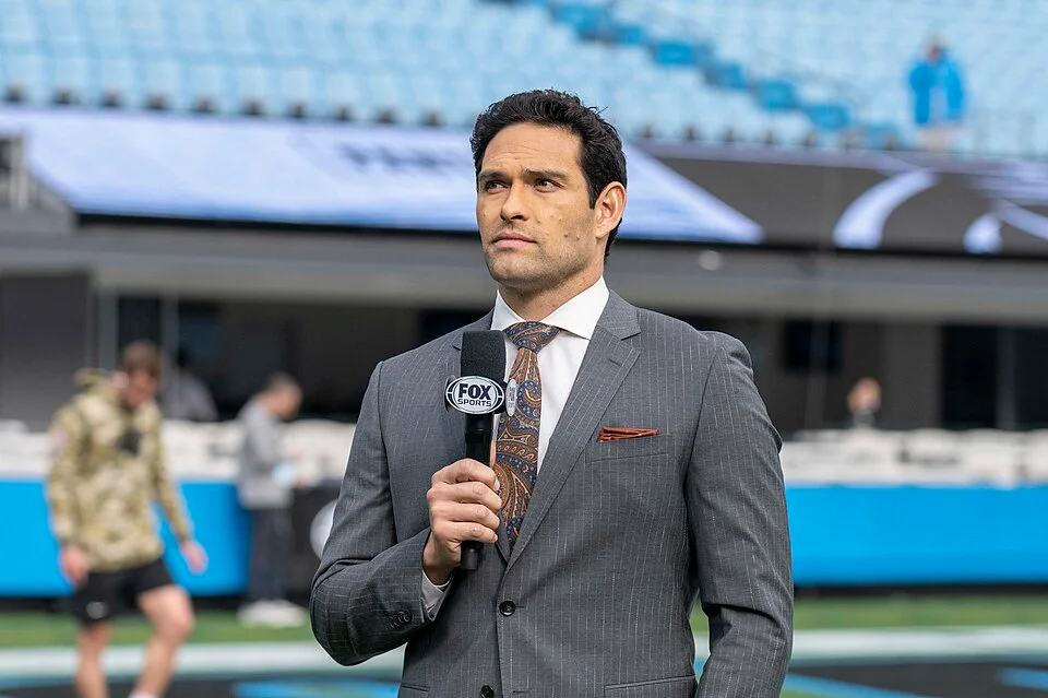 Mark Sanchez Fox Sports broadcaster holding microphone on NFL field