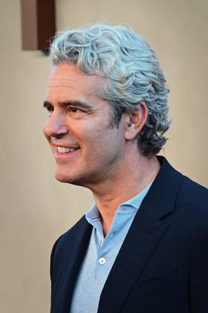 Andy Cohen smiling at event in 2026
