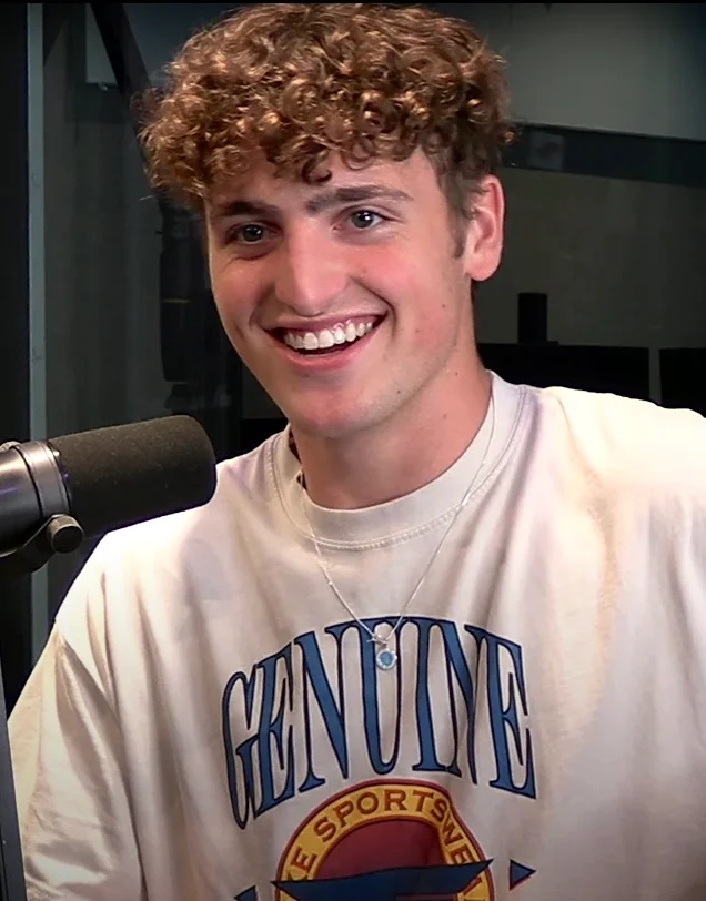 A young Benson Boone smiling during an early radio interview