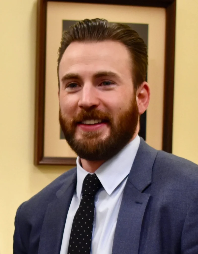 Chris Evans in business suit - 2026 net worth estimated at $110 million