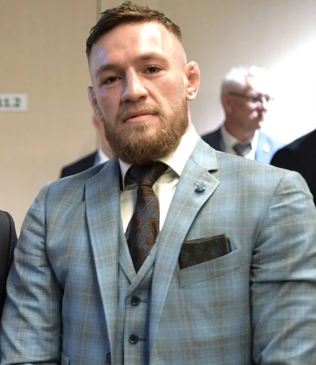 Conor McGregor in a light blue checkered three-piece suit