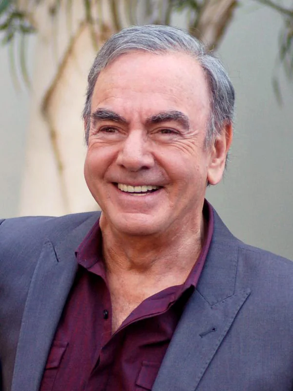 Neil Diamond smiling in a gray suit
