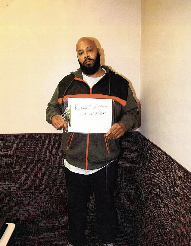 Suge Knight police booking photo holding name placard