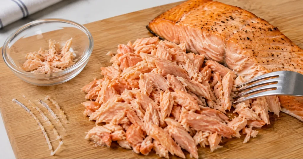 Cooked salmon flaked and deboned for baby-safe preparation
