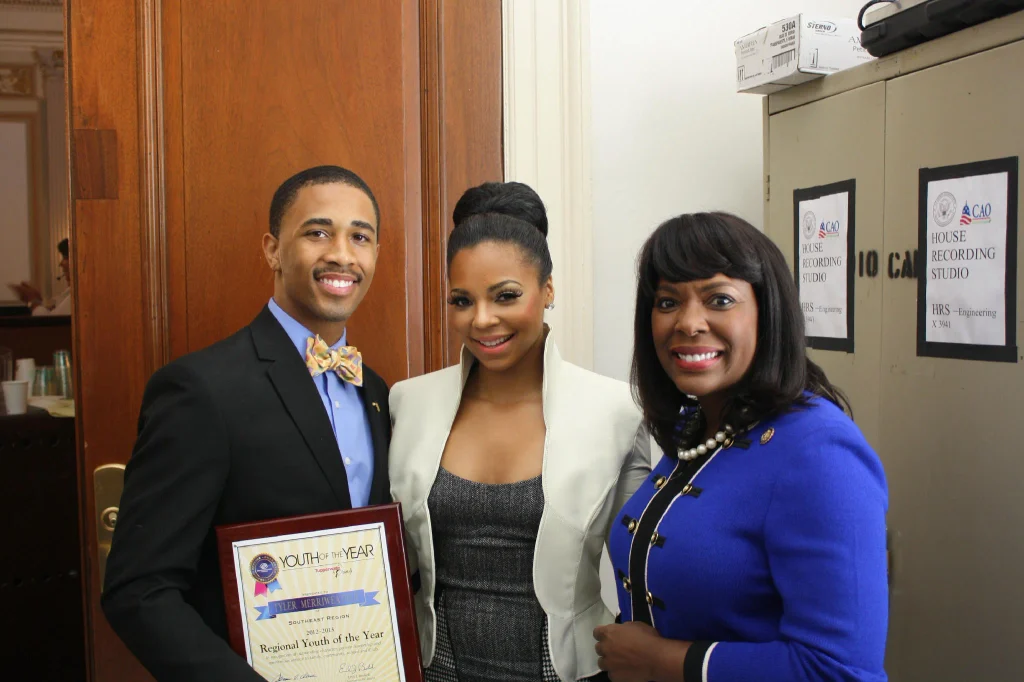 Ashanti posing with a Youth of the Year award recipient at a community event.