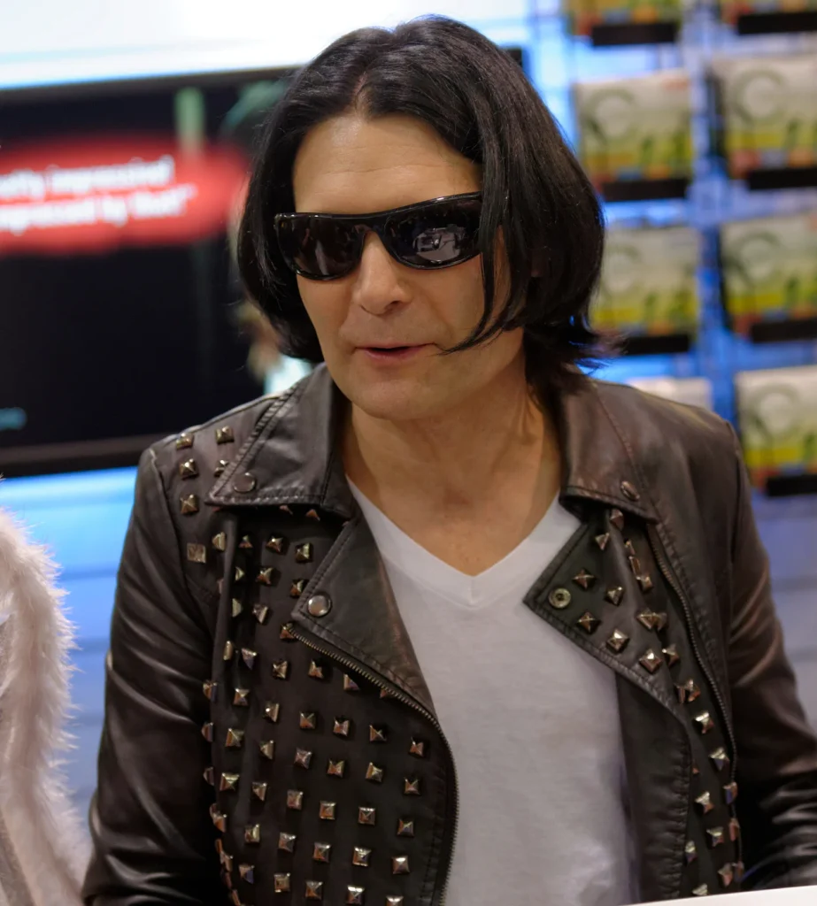 Corey Feldman wearing sunglasses and studded leather jacket at convention appearance