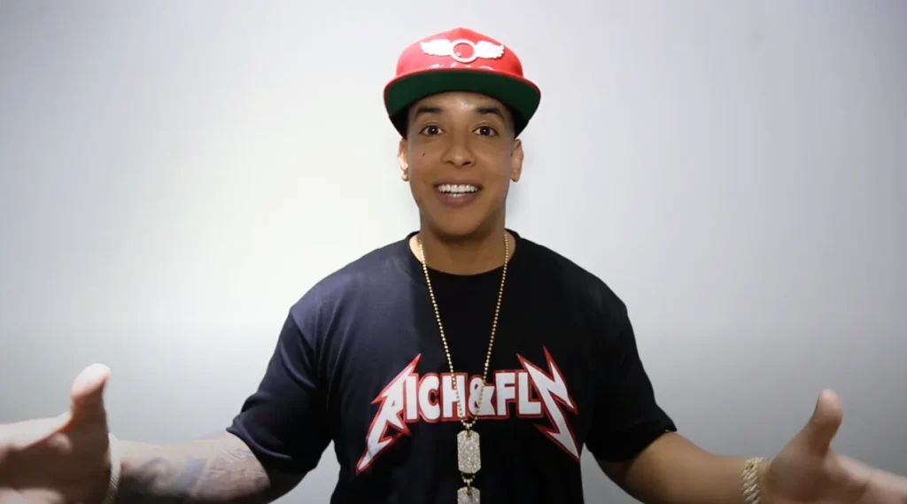 Daddy Yankee smiling in Rich & Fly shirt