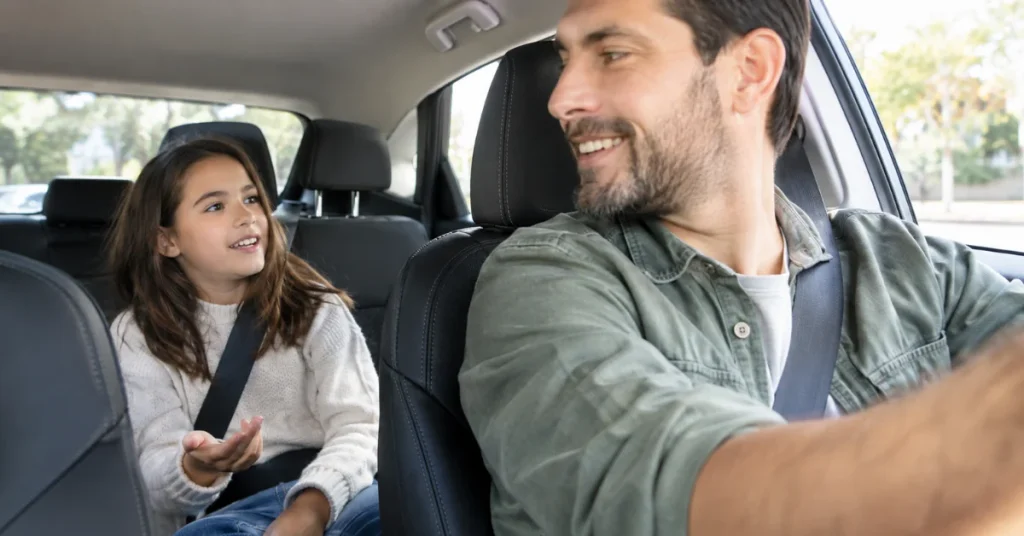 Father and daughter talking during one on one time on a car ride together